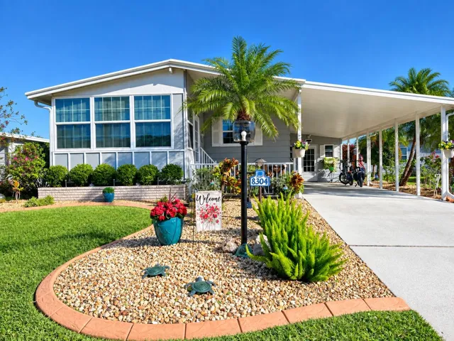 Attractive exterior with low maintenance landscaping, curbing, decorative rock and plantings.