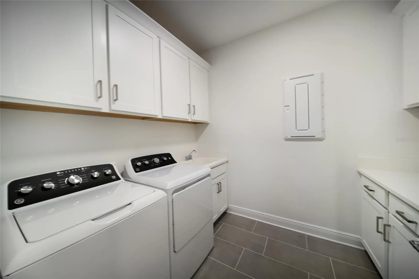 First Floor Laundry Room with Sink and Storage