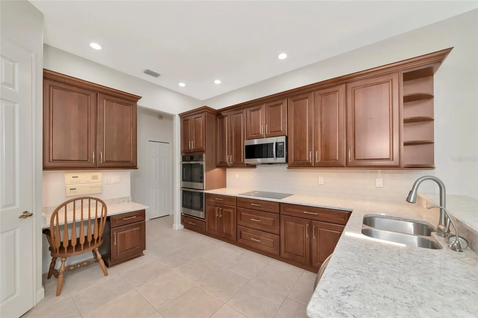 Corner pantry, 42" custom upper cabinets, soft close, under cabinet lighting.