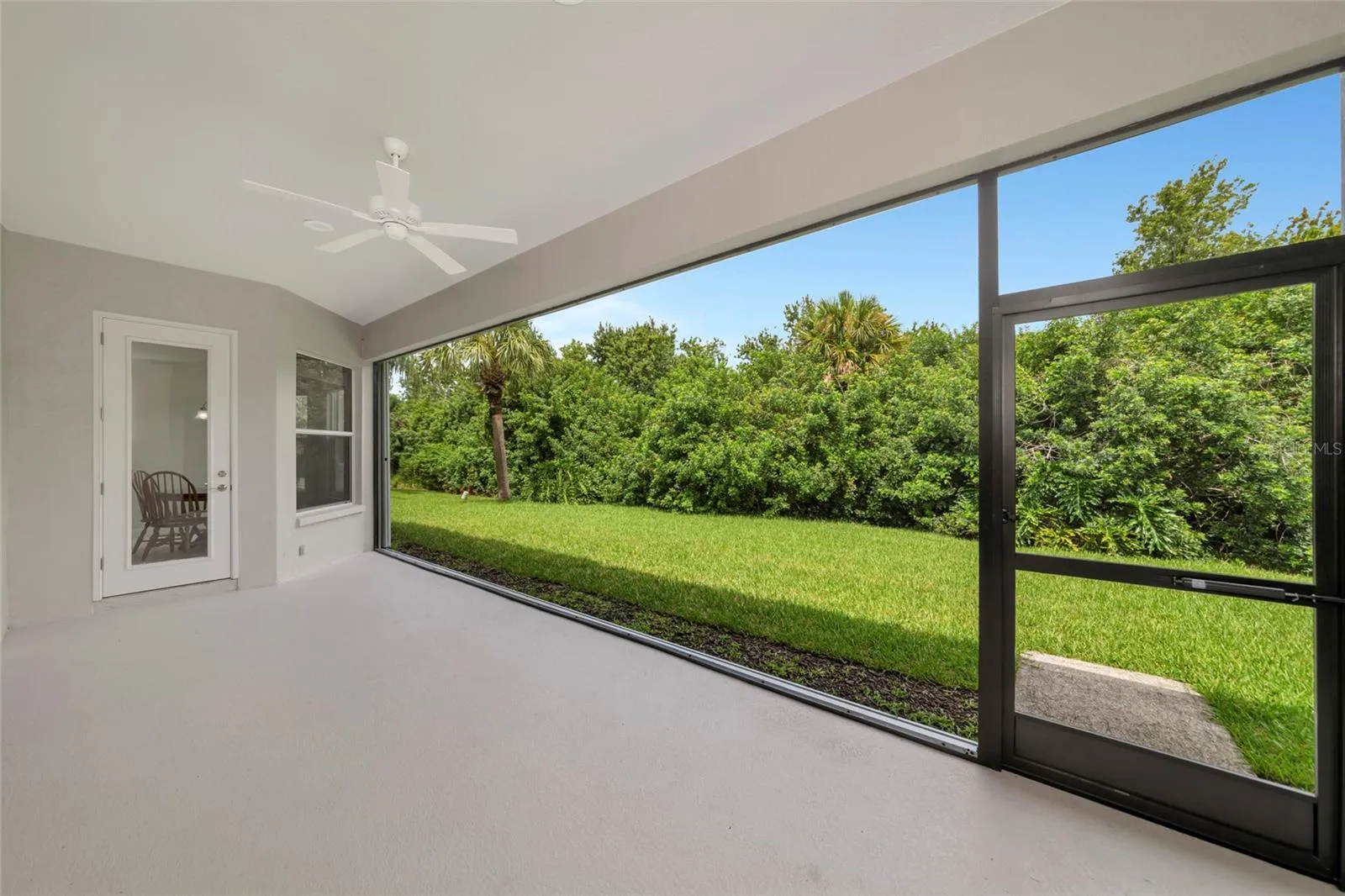 Kitchen cafe door to 31 x 10 lanai w/panoramic screen and large yard view to preserve.