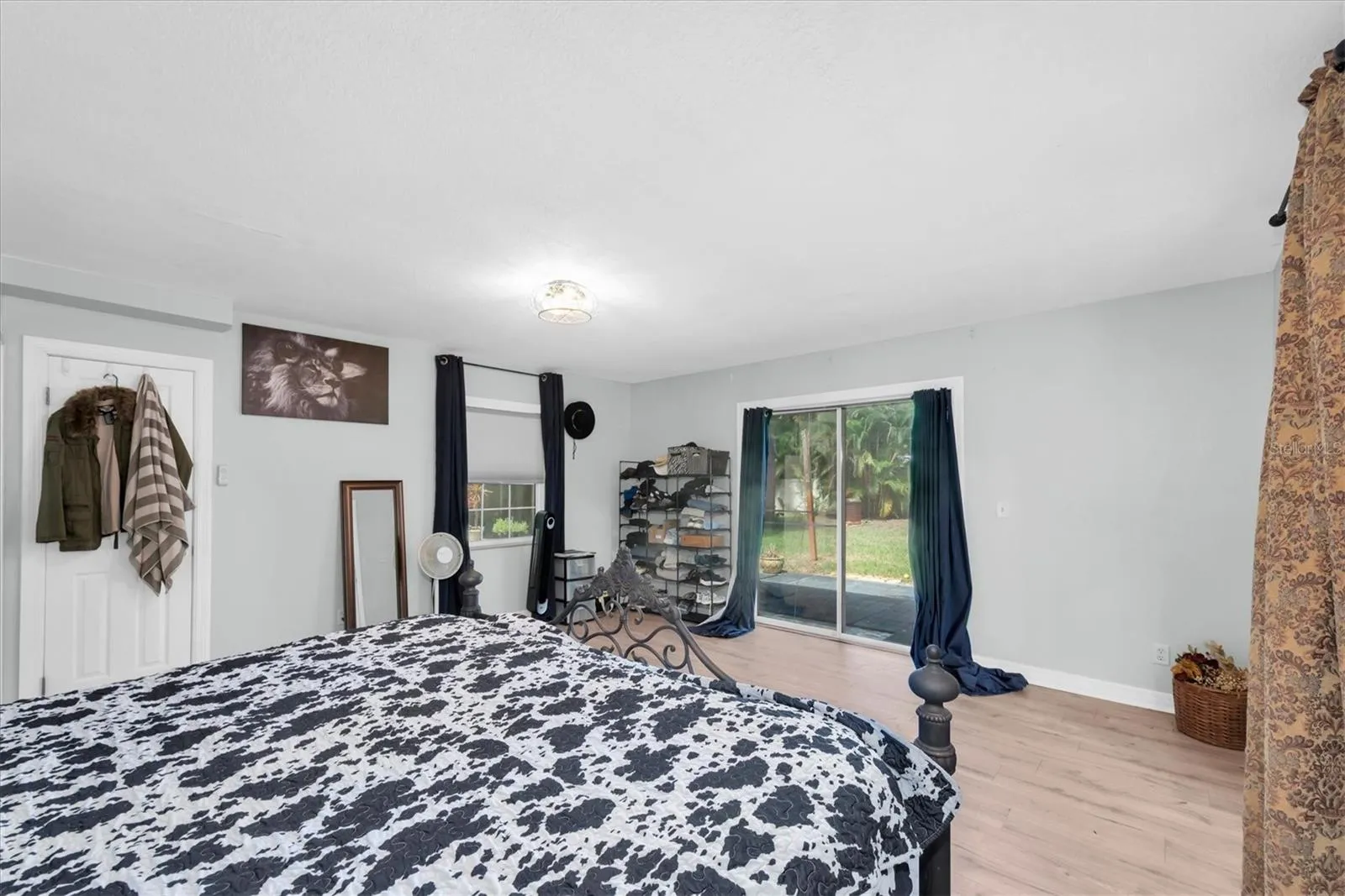 Primary bedroom leads out the the backyard oasis