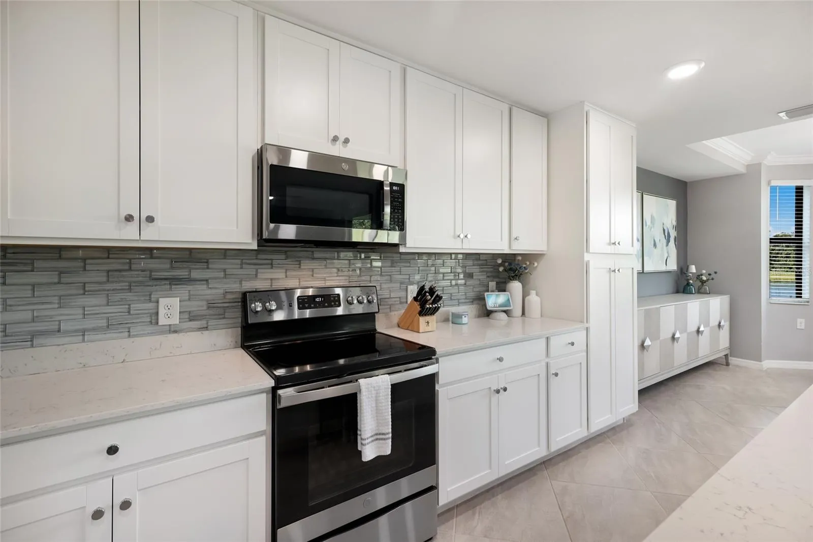 New glass backsplash and tons of cabinet storage