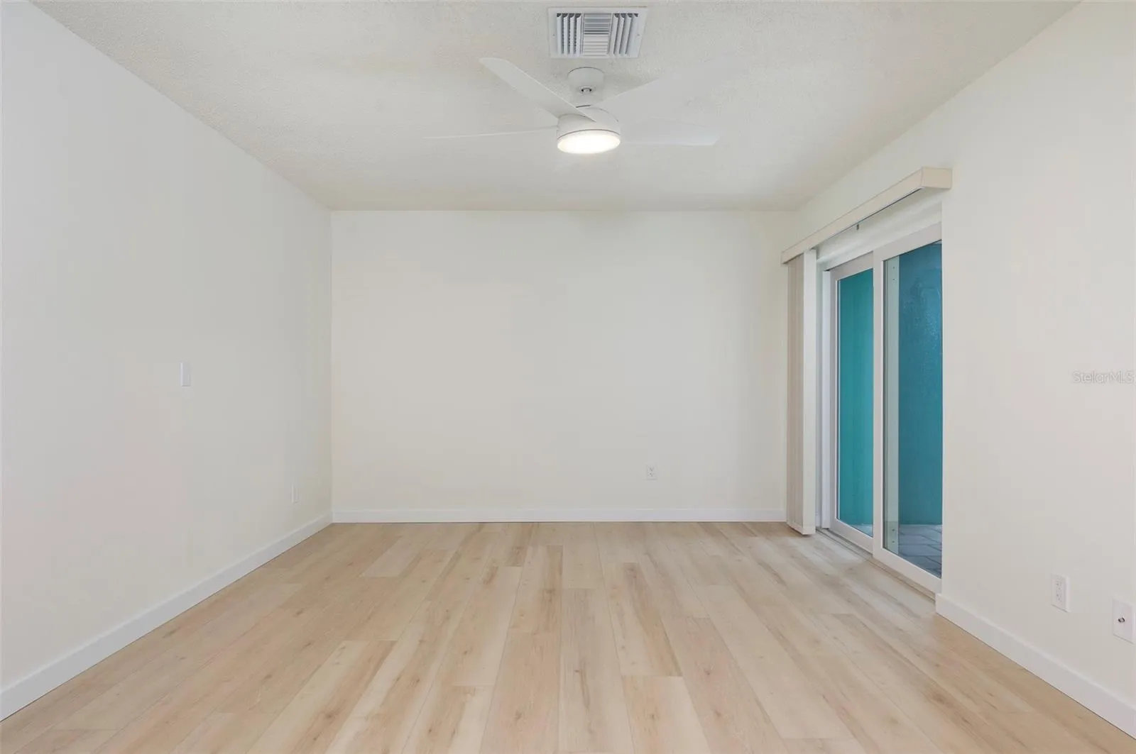 Split Plan Bedroom #2 in the front of the house. Hurricane-rated sliders lead out to your private courtyard.