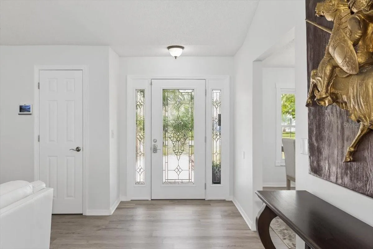 A welcoming foyer greets you upon entry, setting the tone for the warm and inviting living spaces beyond.