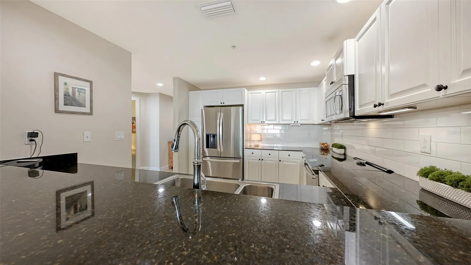 Black Granite CountersWhite Tile Backsplash
