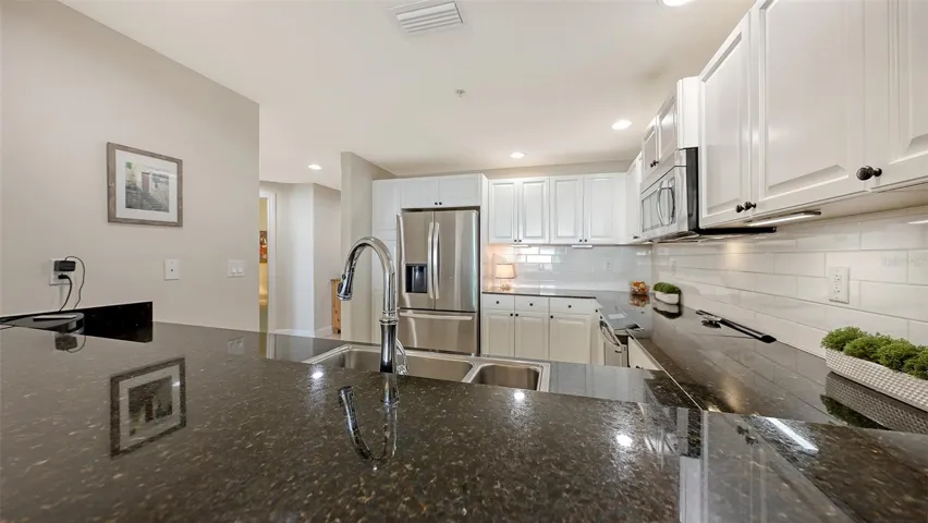 Black Granite CountersWhite Tile Backsplash