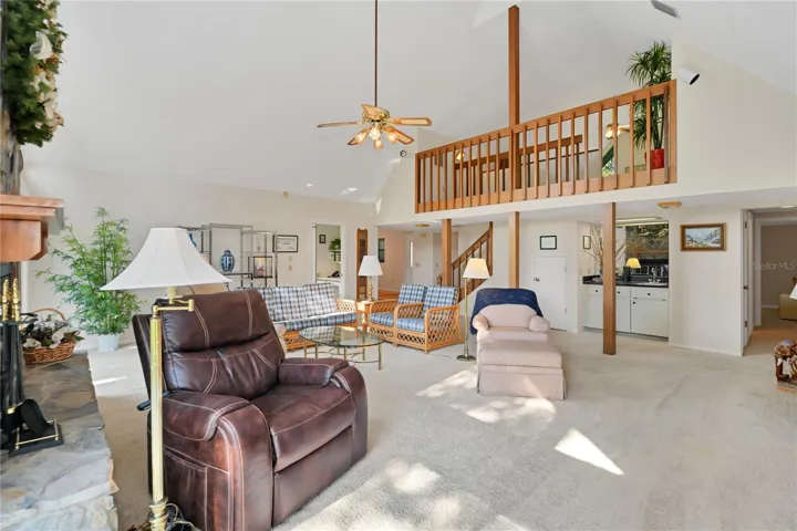 Living Room view w/ Loft and Bar in background
