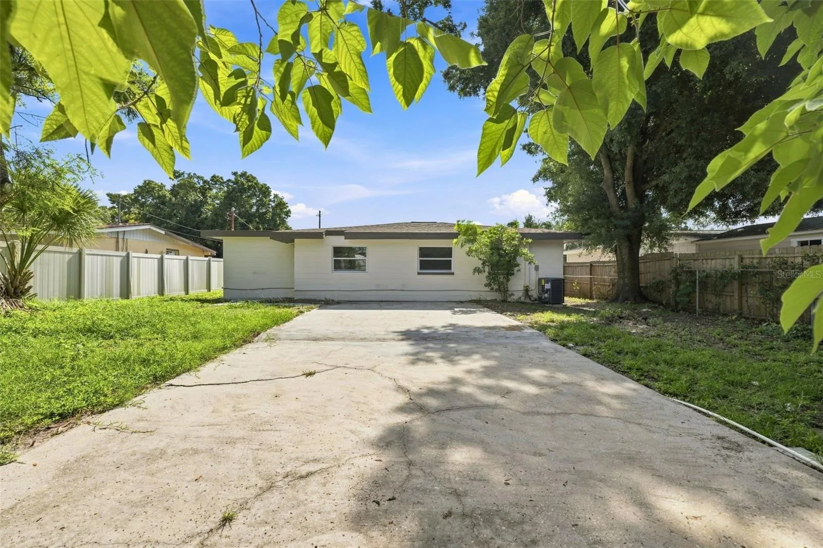 Spacious backyard with concrete patio