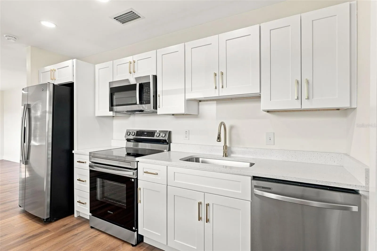 White shaker cabinets and quartz countertops