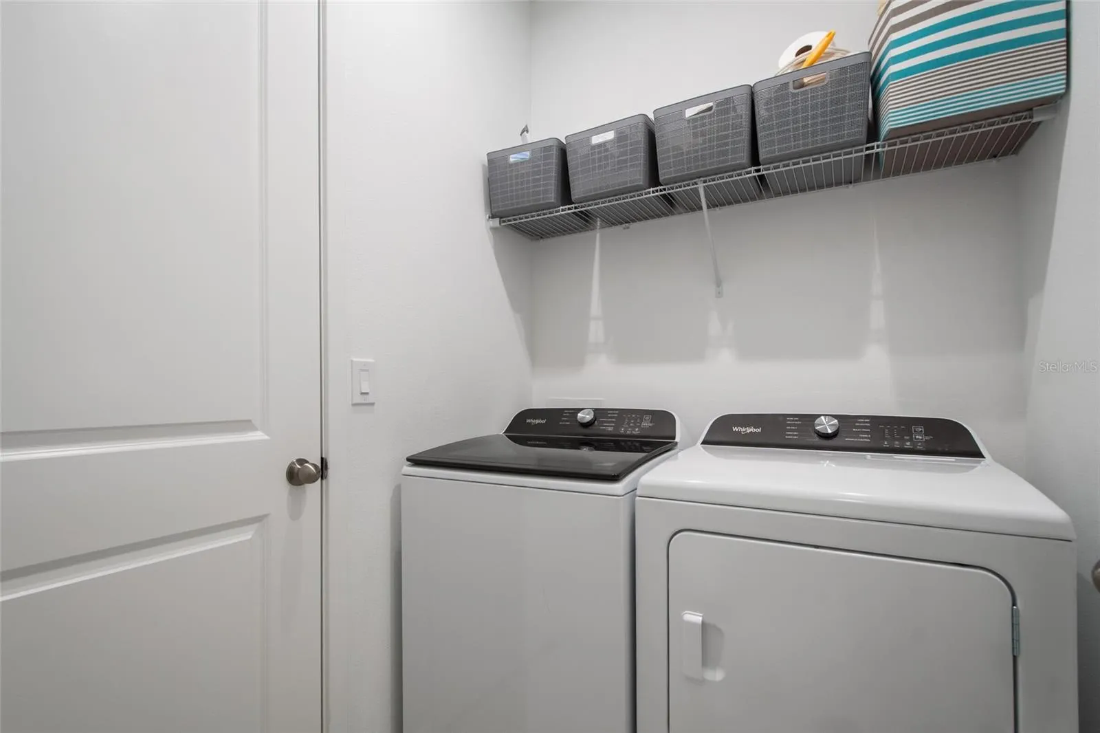 In the same hallway as Bedroom 4 and Bathroom 3 is the laundry room complete with washer and dryer hook up and shelving for laundry essentials.