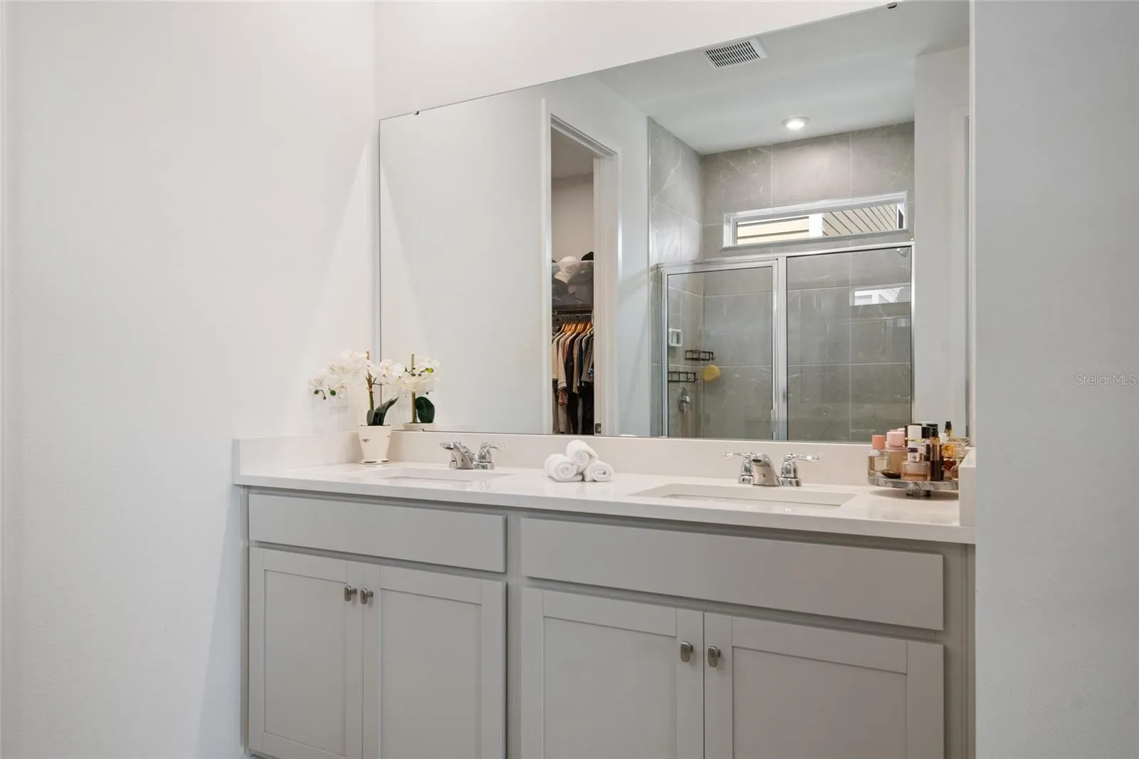 Plenty of storage and double sinks allow togetherness in prepping for the day.