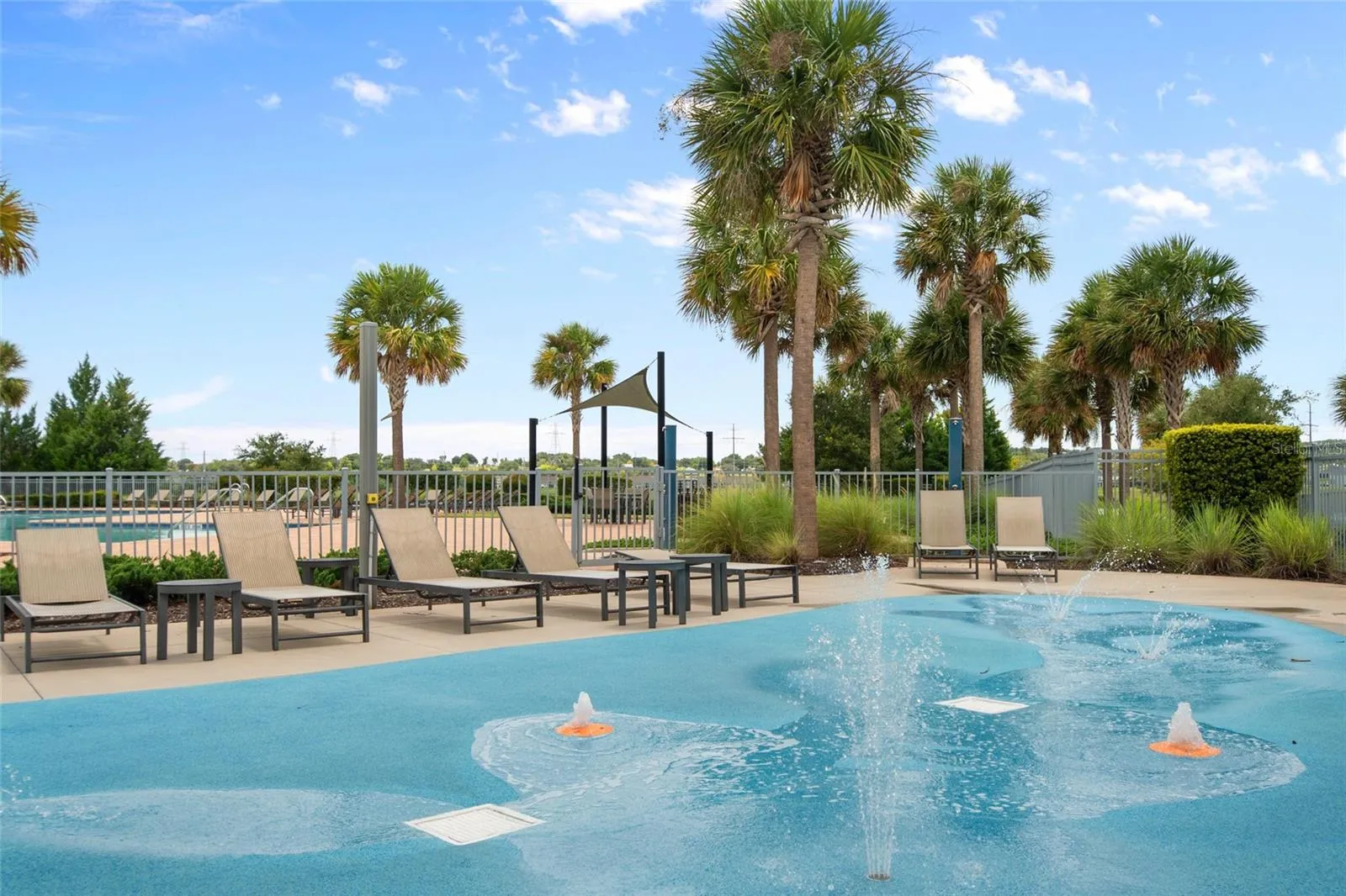 Kids dedicated splash pad area with ample seating for mommy and daddy