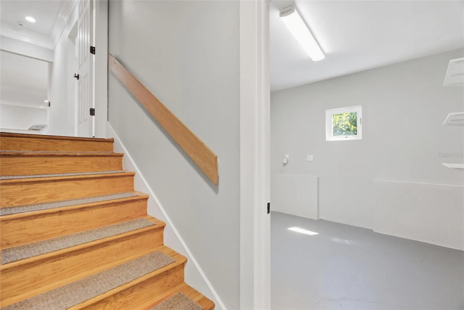 Stairway to garage and additional storage room