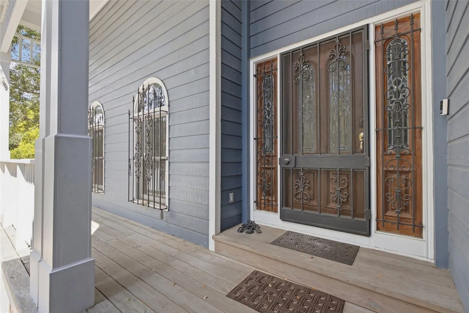 Covered entry porch with ironwork detail