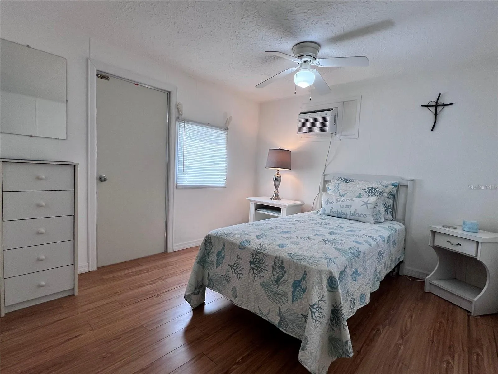 Bedroom with exterior door to patio and shed.