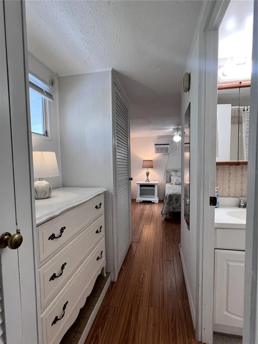 Hallway to bedroom with extra closet space