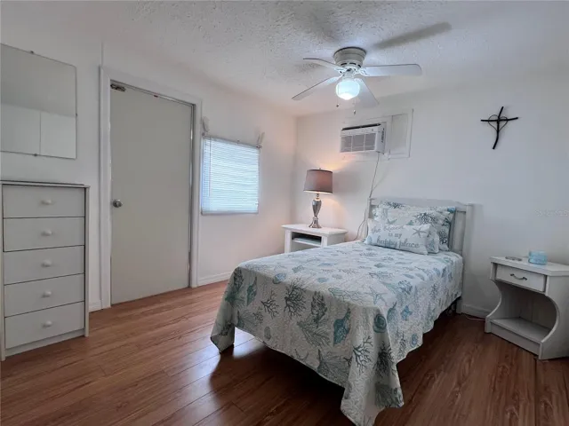 Bedroom with exterior door to patio and shed.