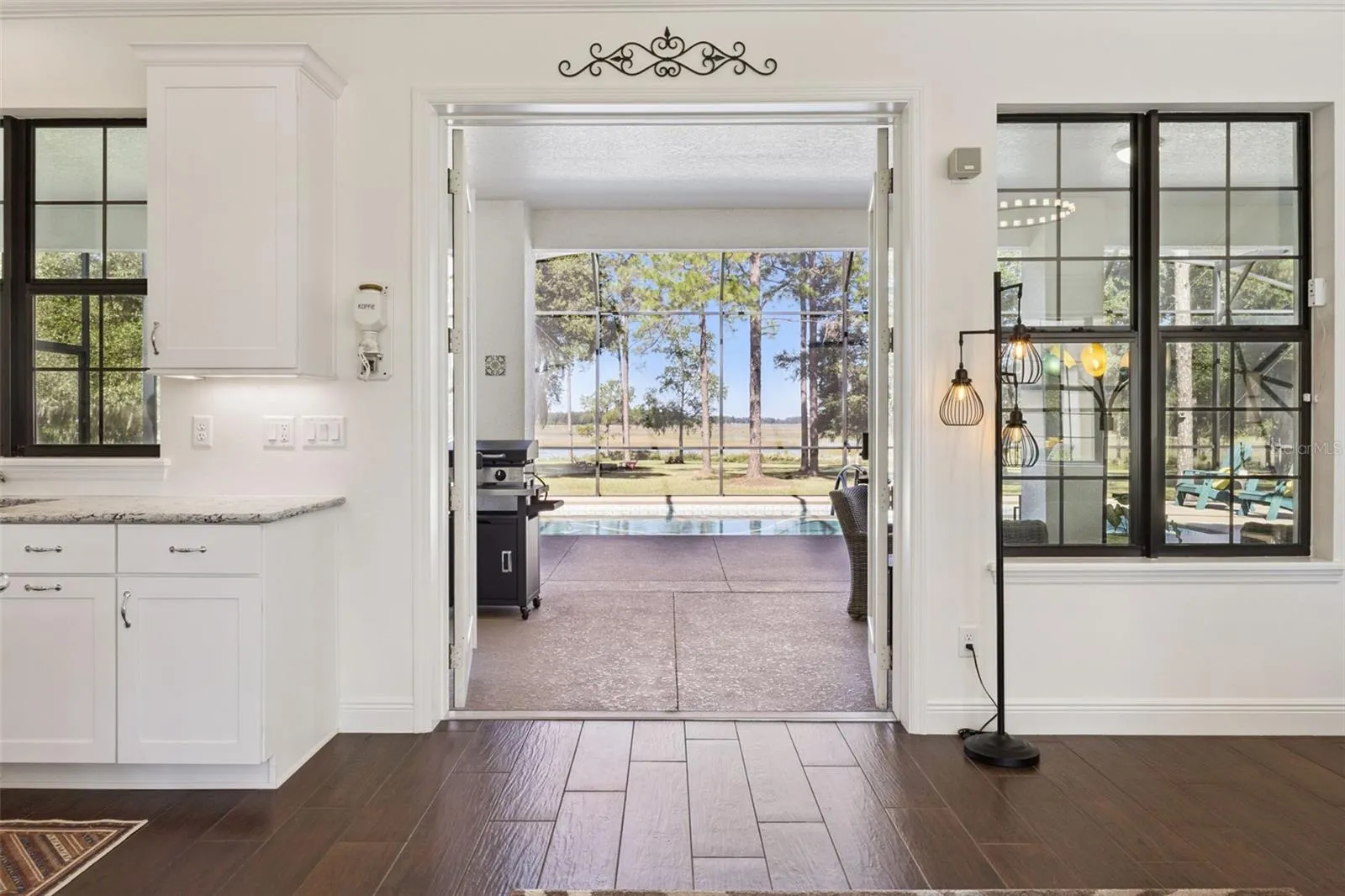 French Doors lead out to the Pool Lanai
