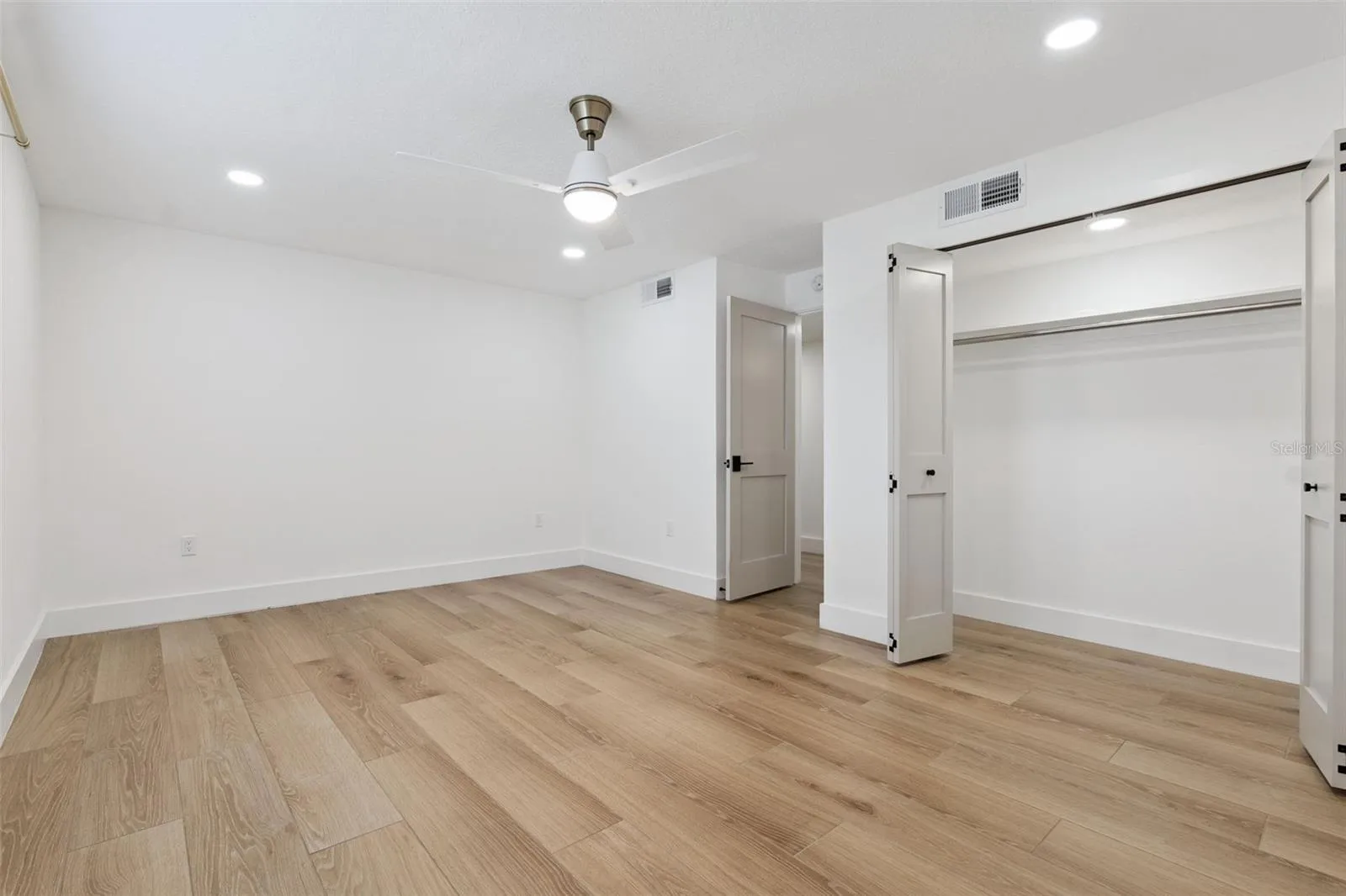 Bedroom with full wall closet, ceiling fan &amp; recessed lighting