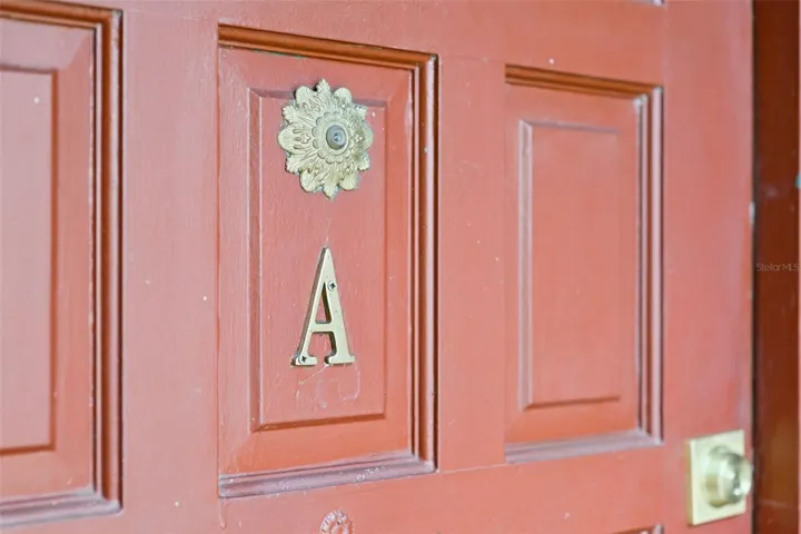 Entry door features a timeless brass detail