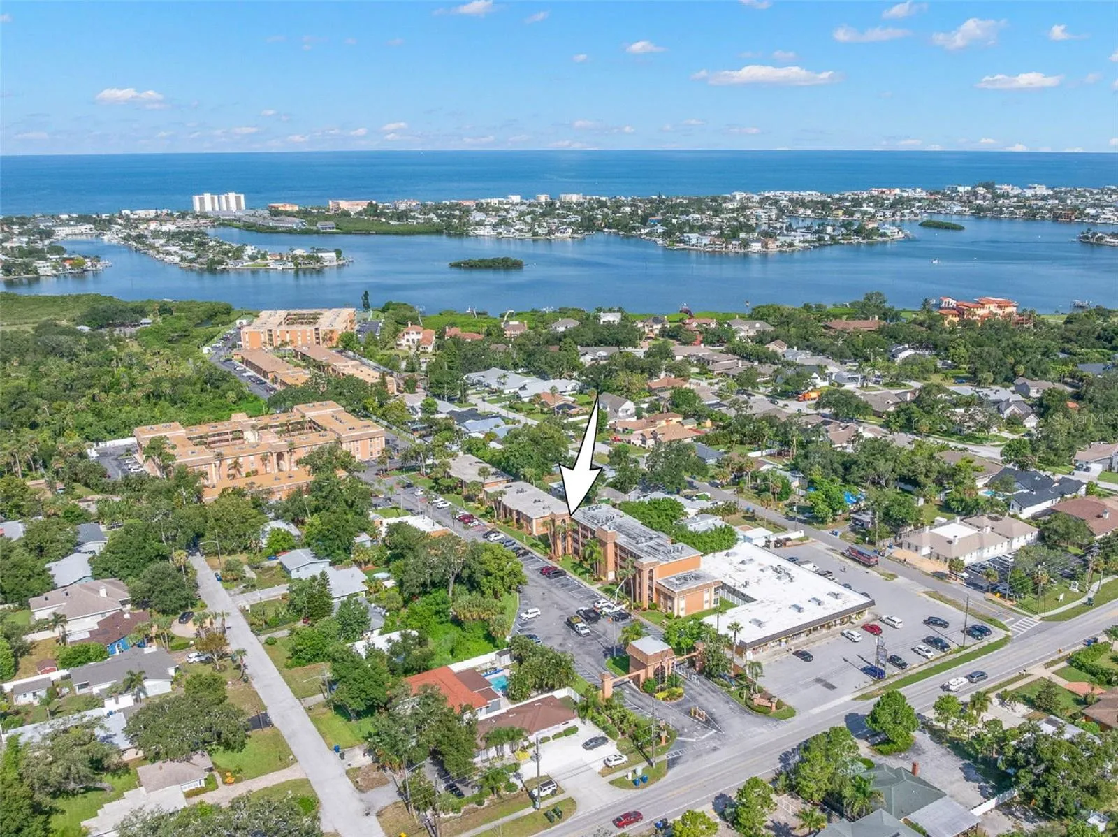 The community’s location comes into focus from above, with the Intracoastal Waterway and Gulf of Mexico stretching across the horizon and Indian Rocks Beach just beyond.