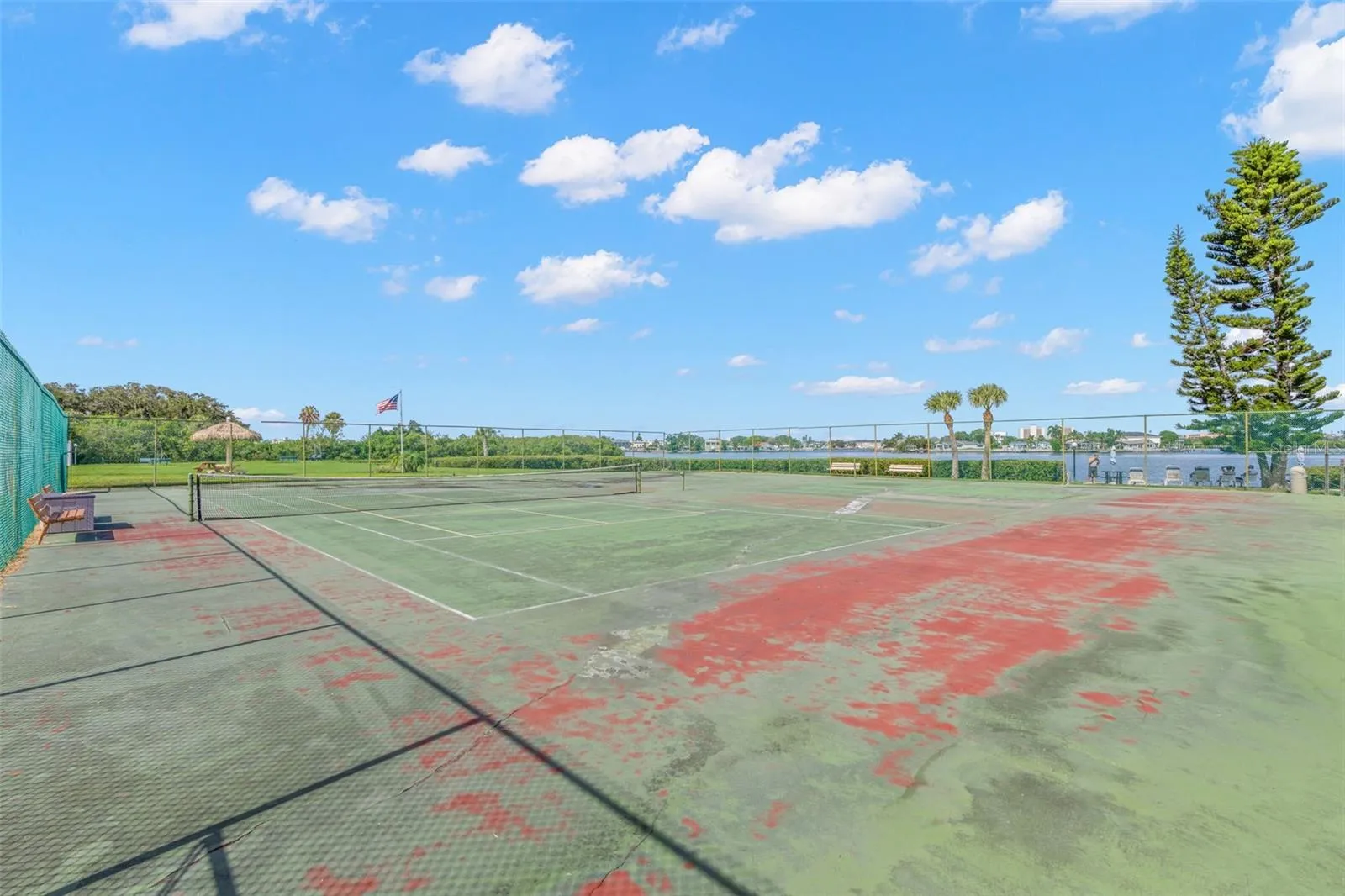 The community tennis courts sit beside the water, pairing another recreational amenity with open views across the surrounding mangroves and Intracoastal setting.