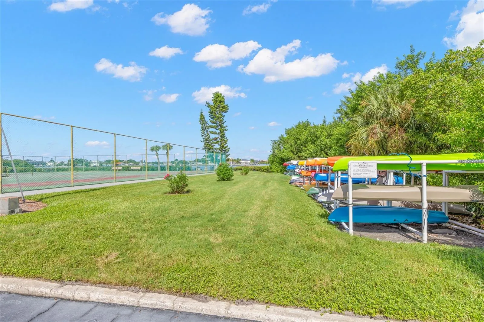 Outdoor amenities continue with tennis courts alongside dedicated kayak storage, adding another recreational option within the New Atlantis Club community.