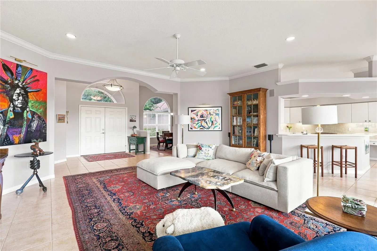 Open-concept great room with high ceilings, crown molding and easy flow to the kitchen and dining areas
