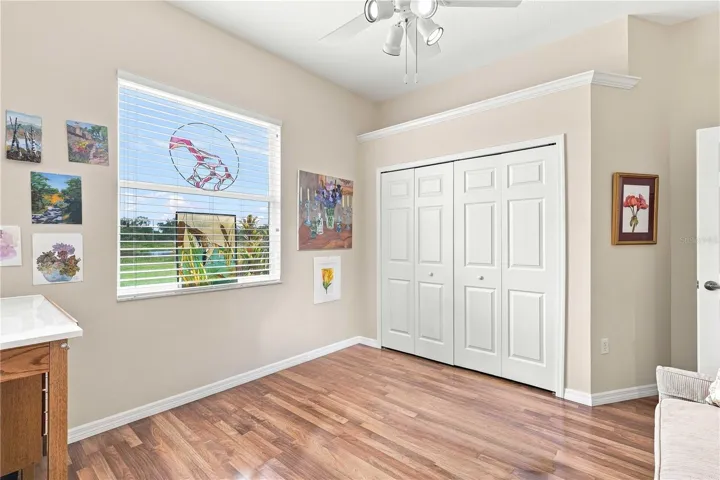 Another view highlighting the hardwood floors, high ceiling and spacious double closet