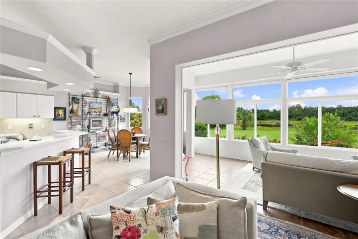 Open living spaces connect the kitchen, dining and Florida room with beautiful backyard views