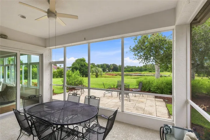 Spacious screened lanai with hurricane screen protection overlooking the lush backyard and peaceful natural setting