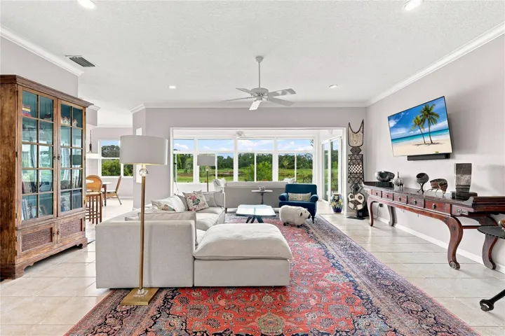 Light-filled great room with crown molding, an open layout and peaceful natural views