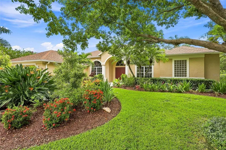 Mature shade trees, colorful tropical plantings and manicured landscaping surround the home, creating exceptional curb appeal and a lush, private setting