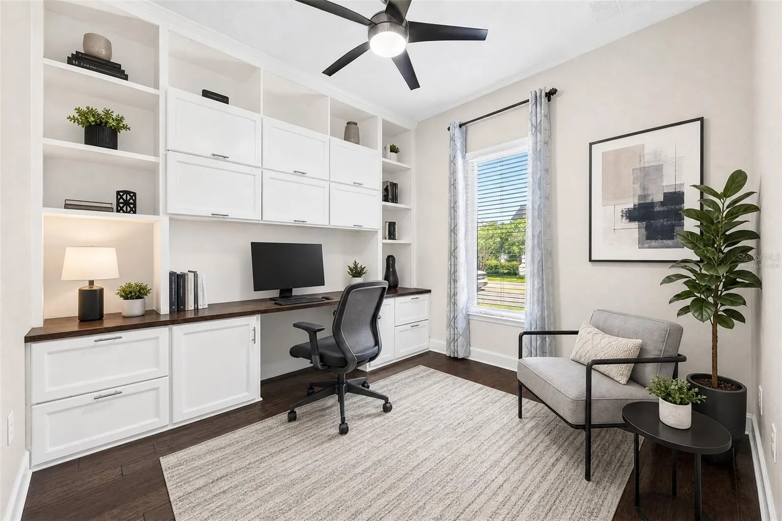 Office/flex space at the front of the home features custom built-ins. Virtually Staged.