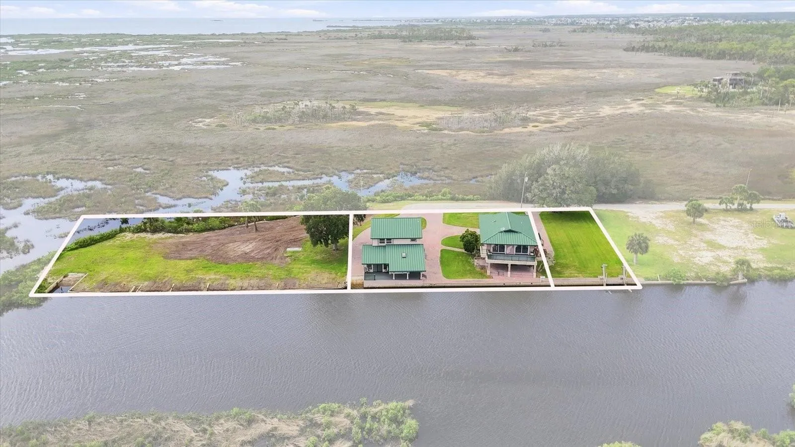 Parcel overview showing the two improved properties together with the adjacent vacant waterfront parcel.