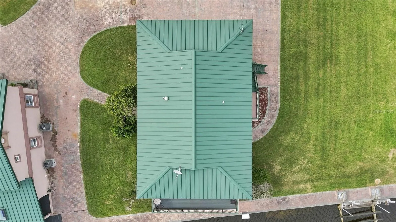 Direct overhead aerial of the main residence and surrounding landscaped grounds.