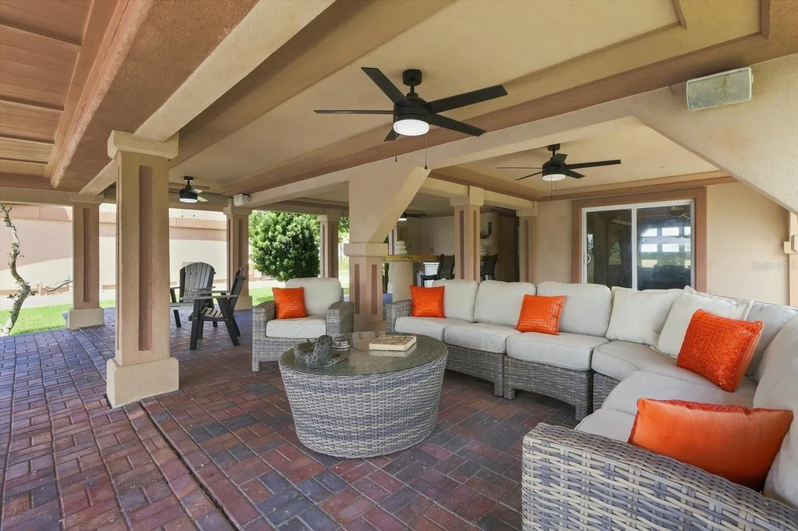 Additional perspective of the covered patio and multiple seating areas.