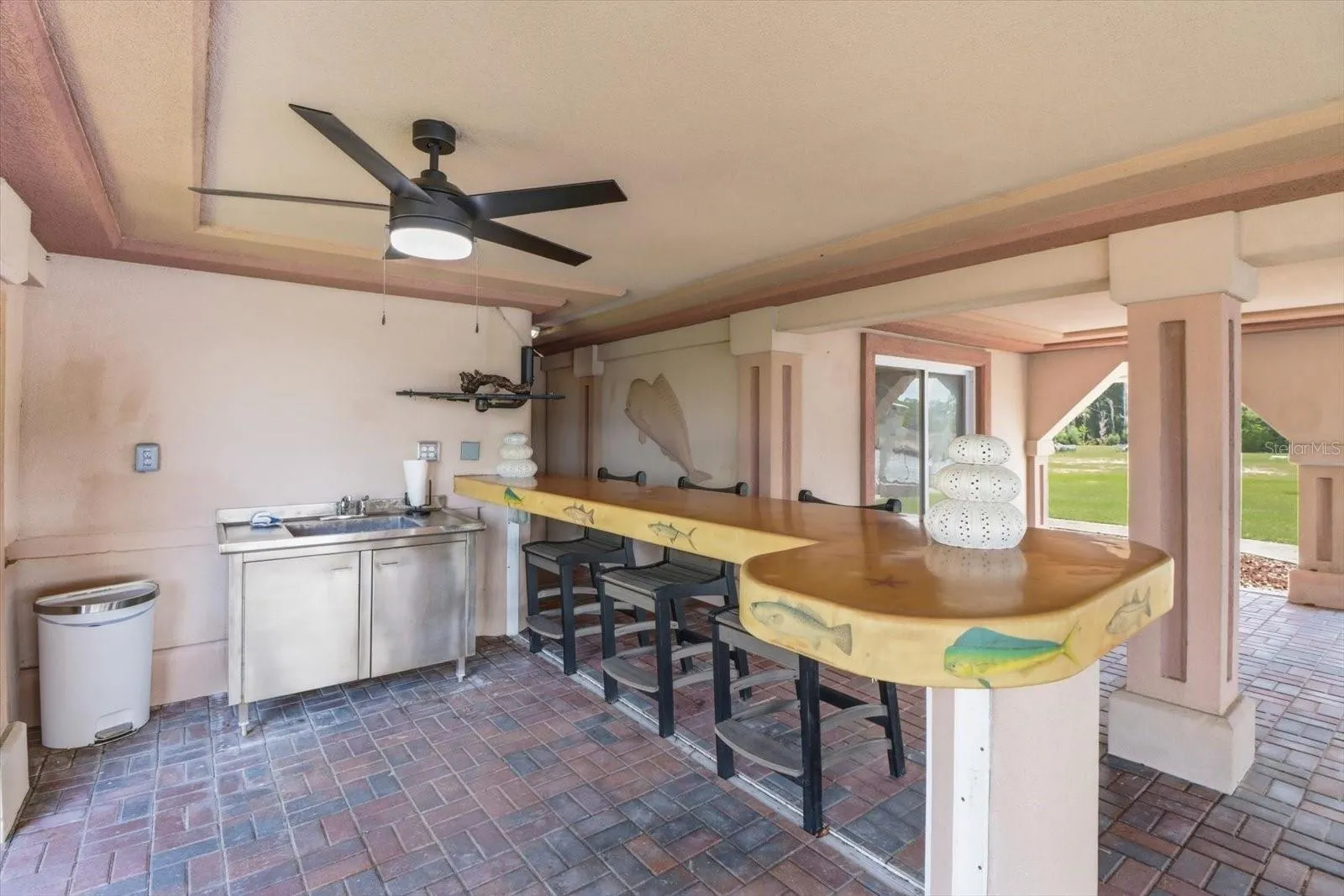Outdoor bar area with stainless sink and generous counter space.