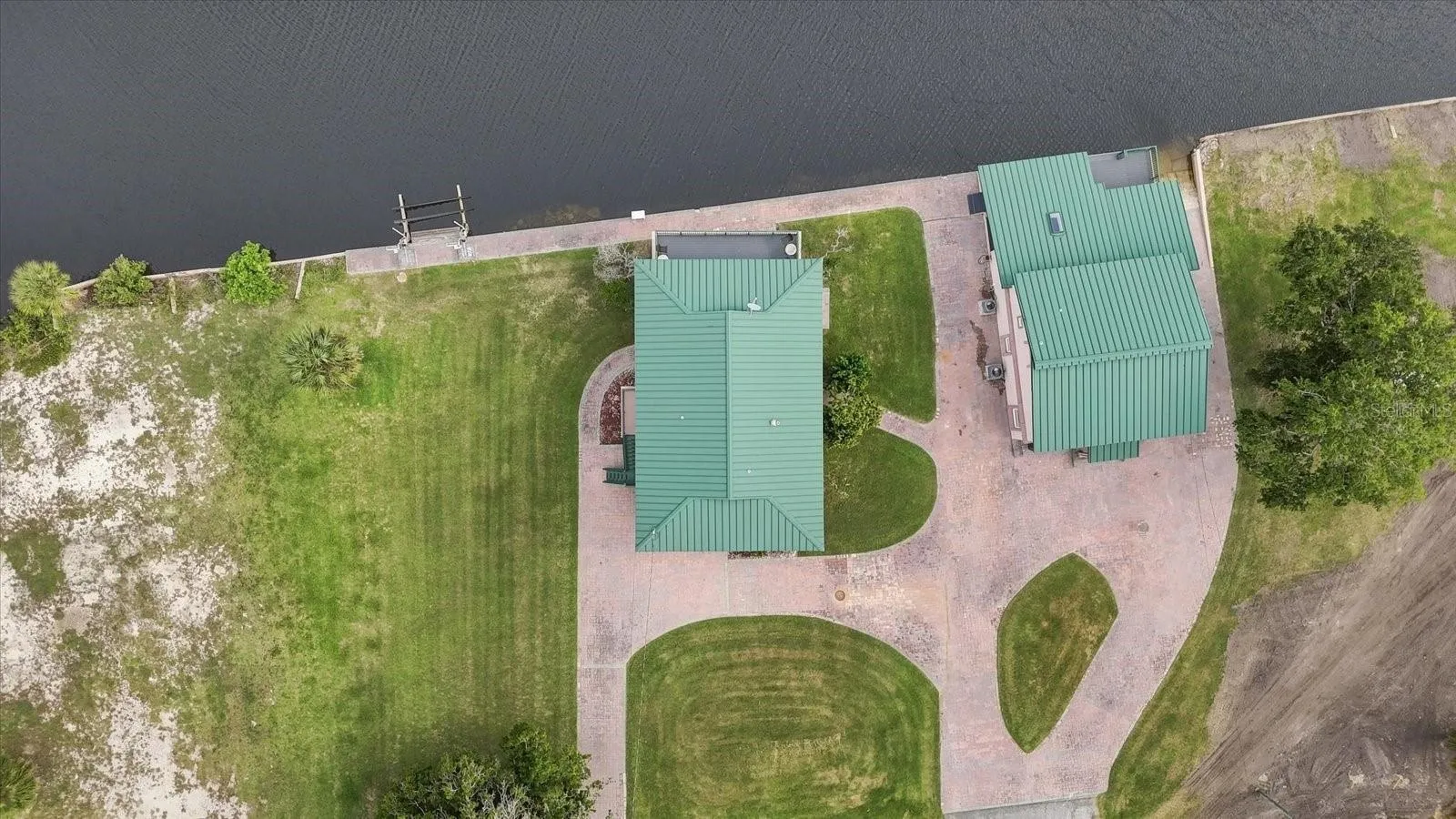 Overhead aerial clearly showing the relationship between both buildings and surrounding improvements.