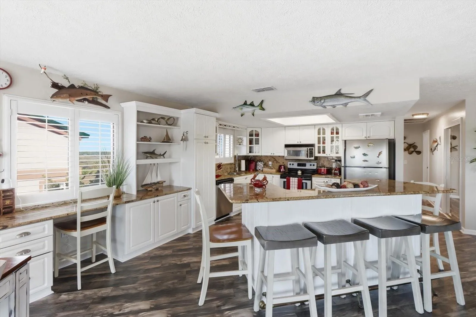 Kitchen and breakfast bar providing abundant seating and workspace.