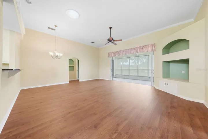 Spacious open living area with a desirable split-bedroom floor plan vaulted ceilings, and warm wood flooring.