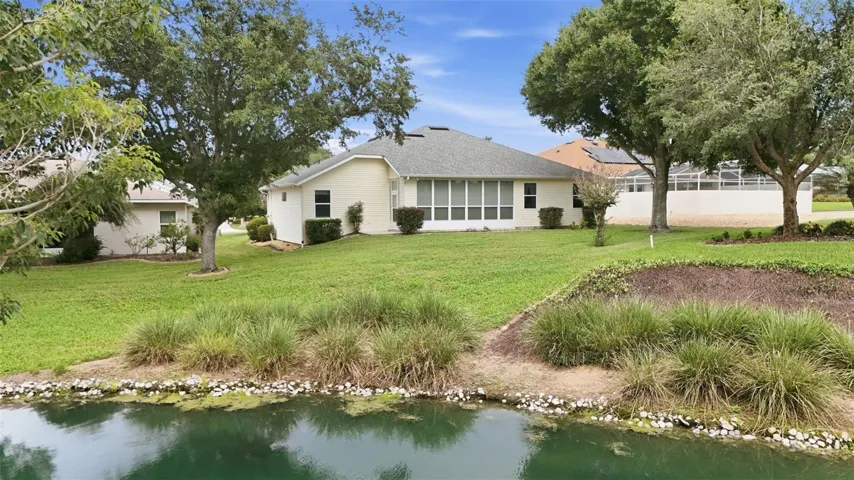 Peaceful water views complement the spacious backyard and enclosed lanai.