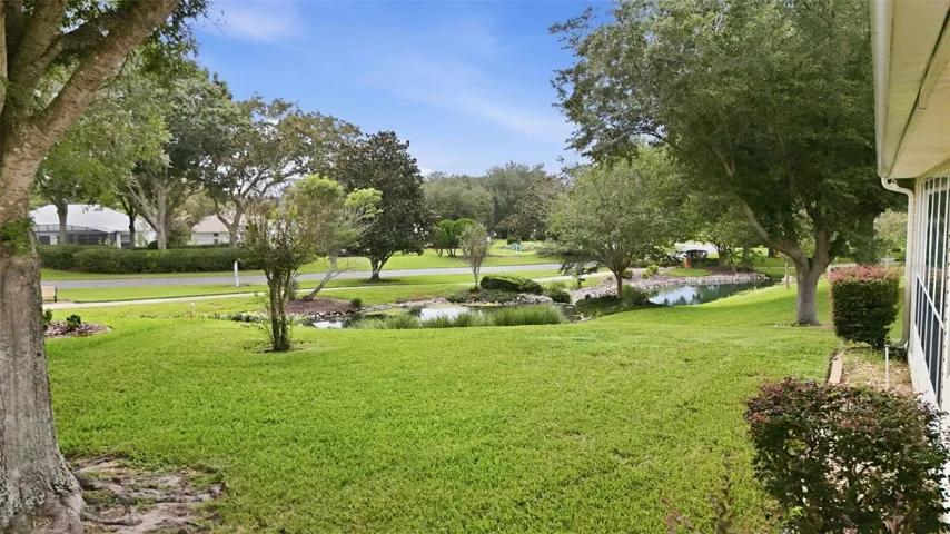 Lovely green space with mature trees and a peaceful water view!