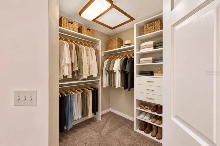 Virtually Staged Primary Bedroom's Walk-In Closet