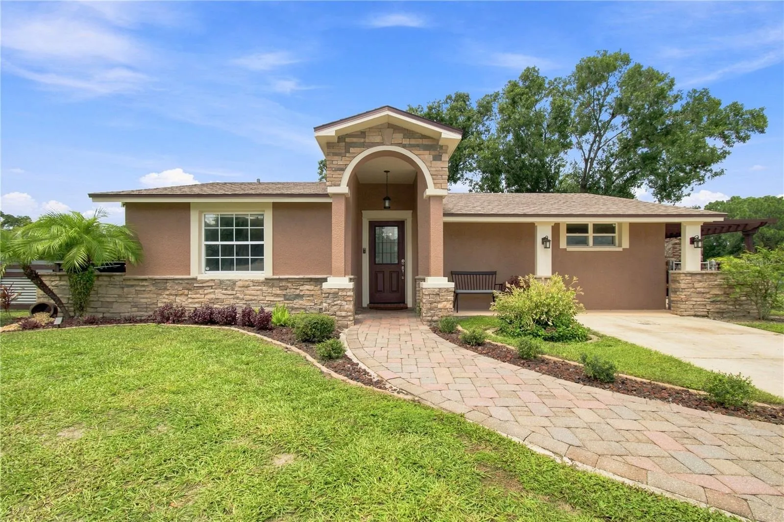 Front View warm color stone decor blends for a cohesive upgrade look, with Portico and Porch, paved walkway to complete the beautiful curb appeal.