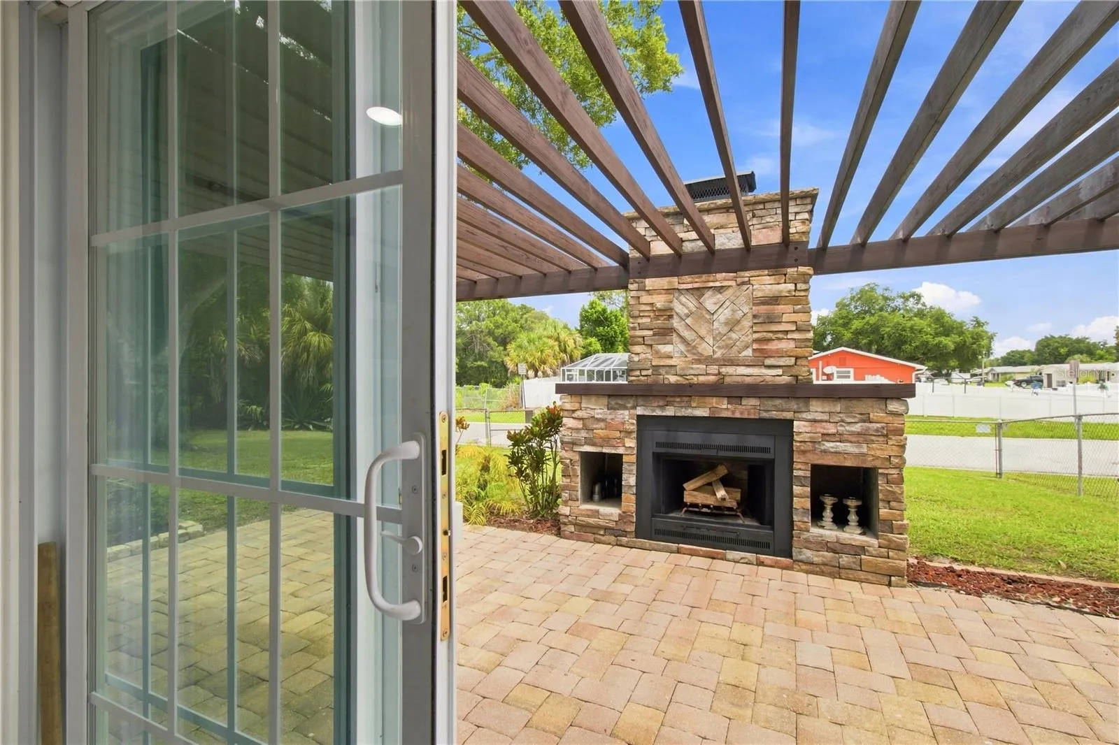Dining area sliders passage to side patio with wood fireplace