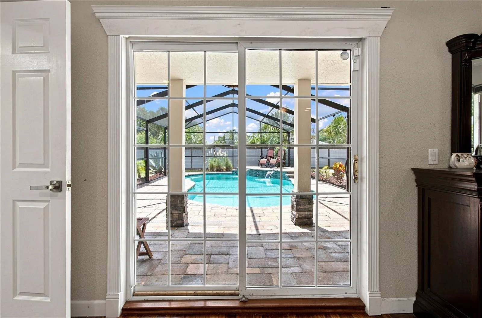 Patio sliders lead to the pool