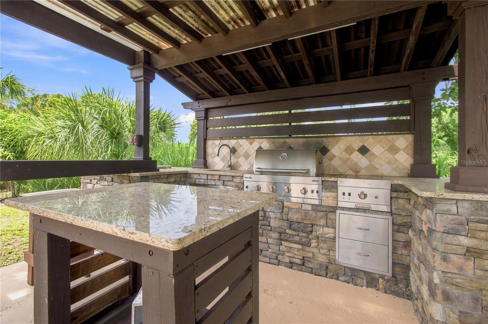 an open-air poolside BBQ cabana