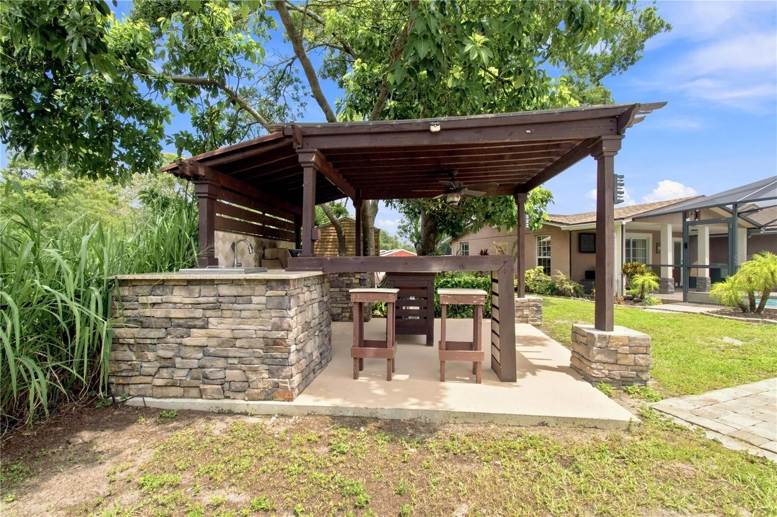 an open-air poolside BBQ cabana