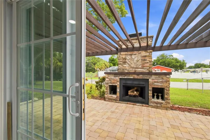 Dining area sliders passage to side patio with wood fireplace